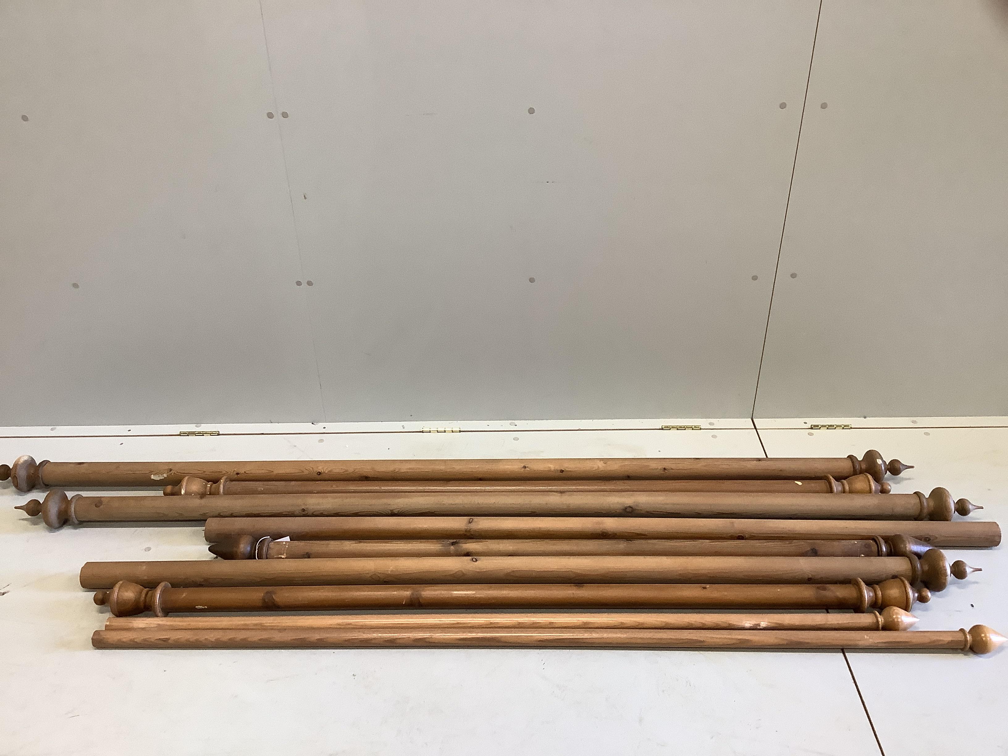 Nine Victorian style pine curtain poles with brackets and rings, largest length 226cm